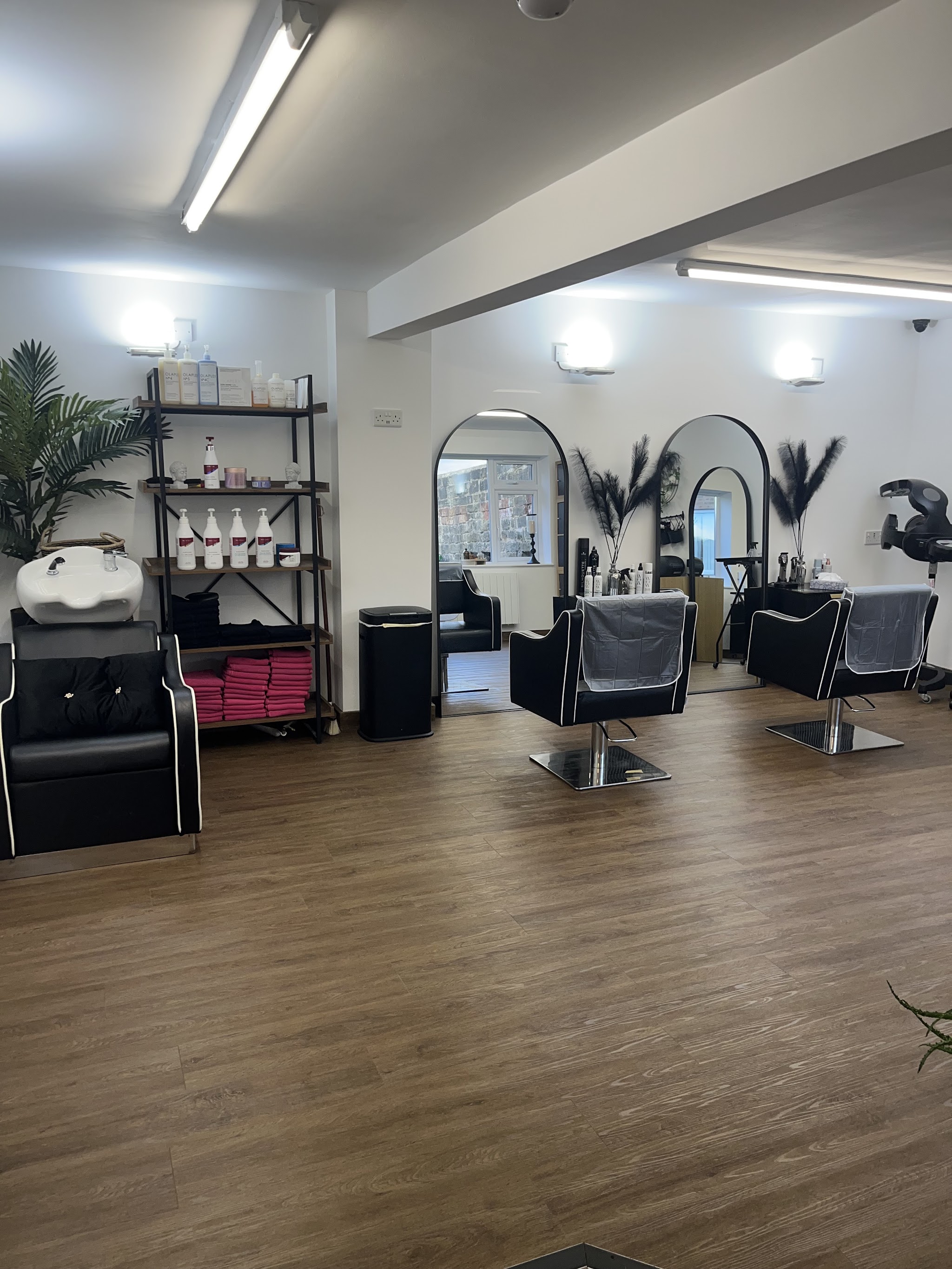 Arched mirrors and black styling chairs inside Static's Rawdon salon